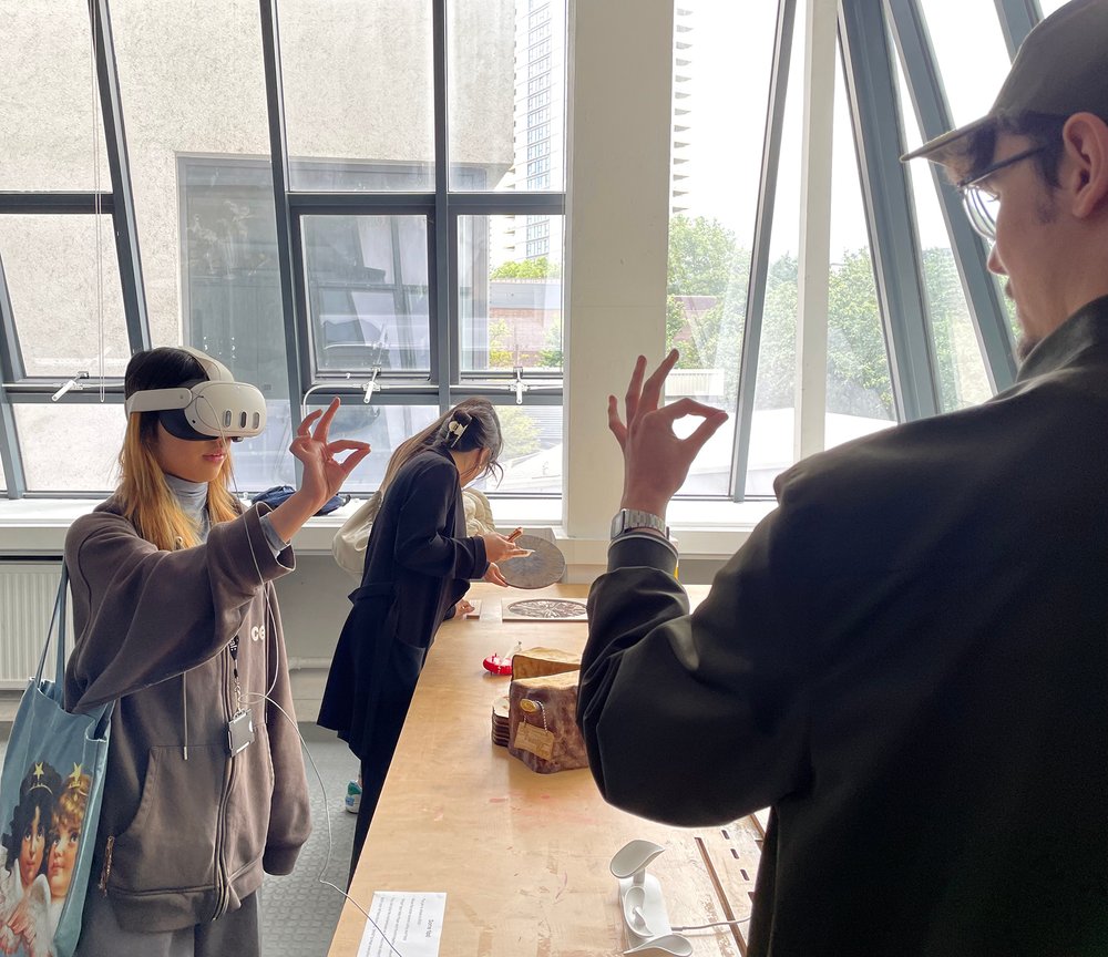 Exhibition view showing a person interacting via VR headset.