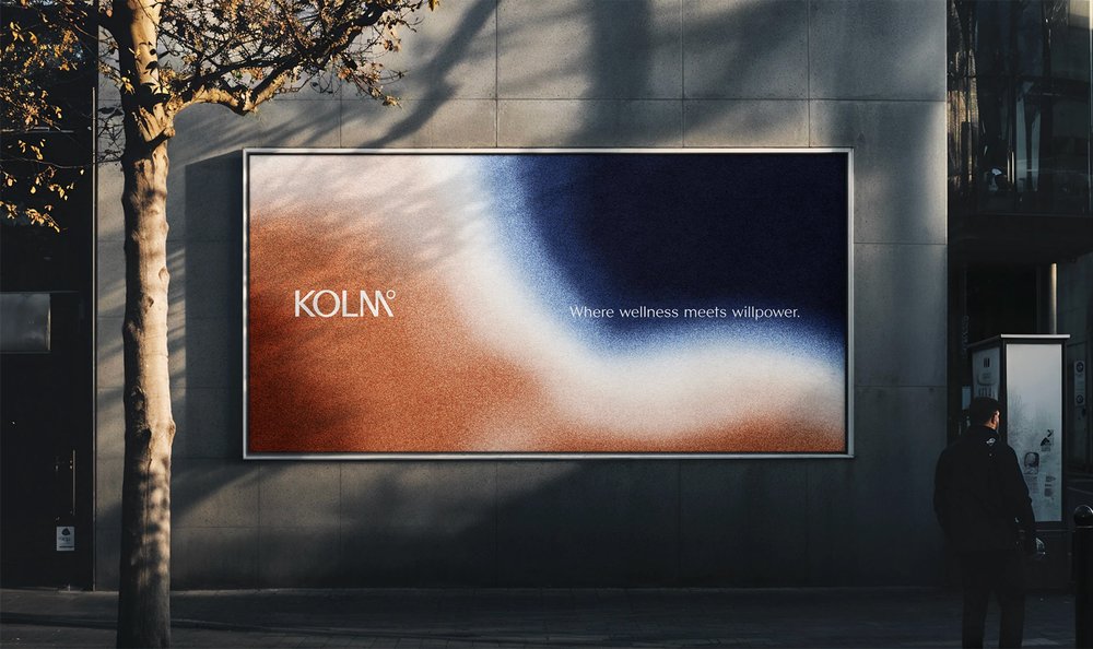 Billboard showing abstract blurred photo in umber, white and dark blue with the brand name in a capitals, serif font
