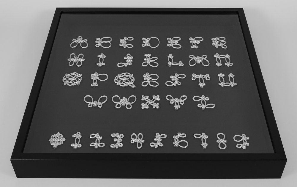 Knotted tyepface presented in a display case