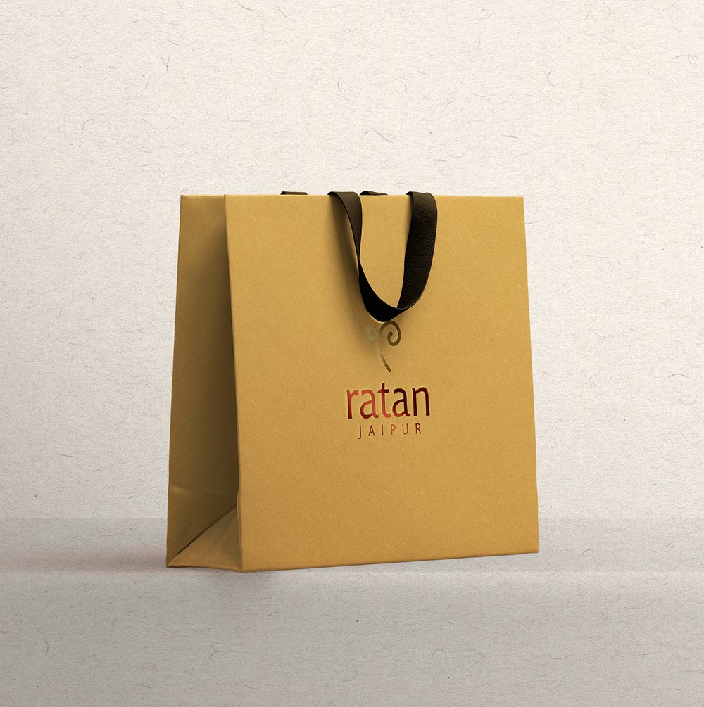 Paper shopping bag with embossed metallic logo