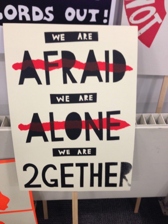 Protest sign about solidarity, reading "we are 2gether"