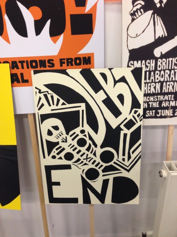 Black and white geometric poster featuring a skeleton and the words "end debt"