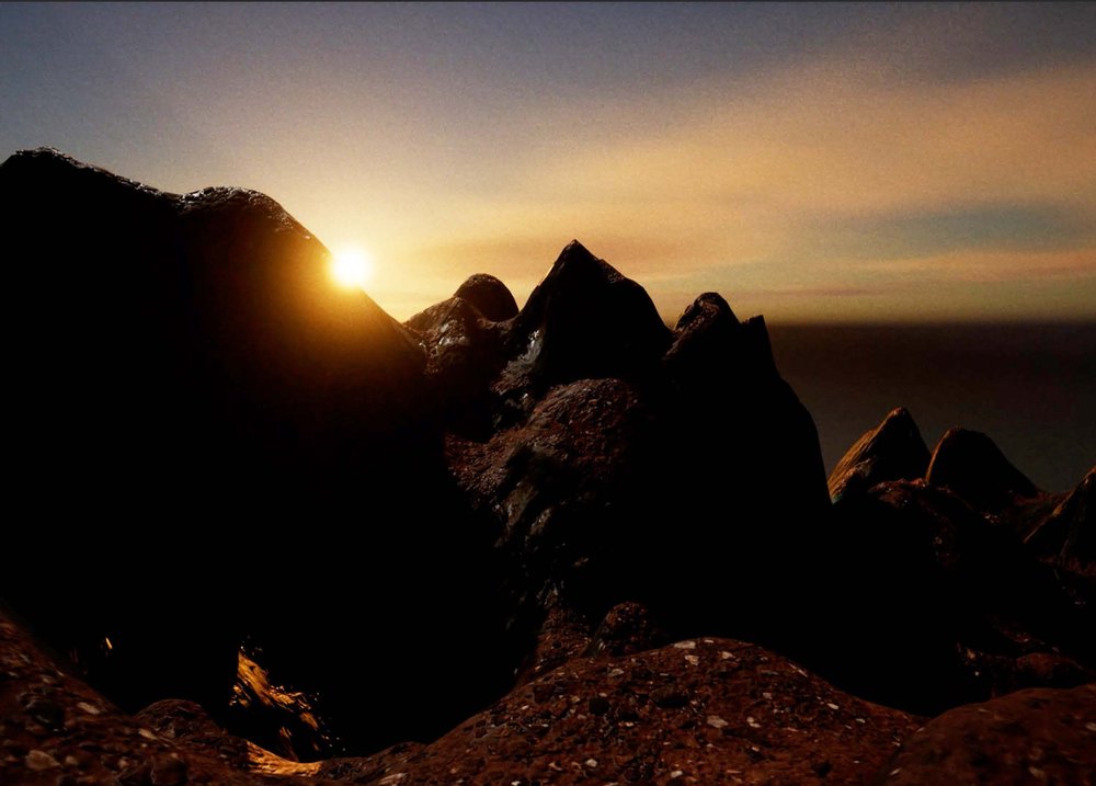 Video still depicting a sunrise over rocks